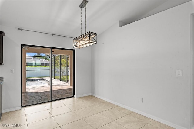 3734 SE 3rd Pl, Cape Coral, FL 33904 - unfurnished dining area with light tile patterned floors, baseboards, an inviting chandelier, and lofted ceiling