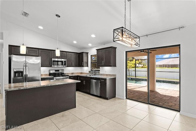 3734 SE 3rd Pl, Cape Coral, FL 33904 - kitchen featuring baseboards, a sink, appliances with stainless steel finishes, vaulted ceiling, and light stone counters