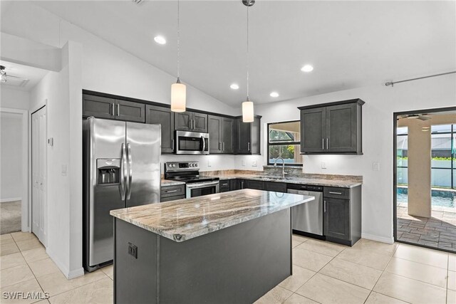 3734 SE 3rd Pl, Cape Coral, FL 33904 - kitchen featuring ceiling fan, a kitchen island, appliances with stainless steel finishes, light stone counters, and a sink