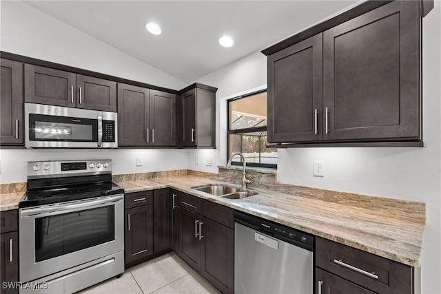 3734 SE 3rd Pl, Cape Coral, FL 33904 - kitchen featuring appliances with stainless steel finishes, a sink, lofted ceiling, and dark brown cabinetry