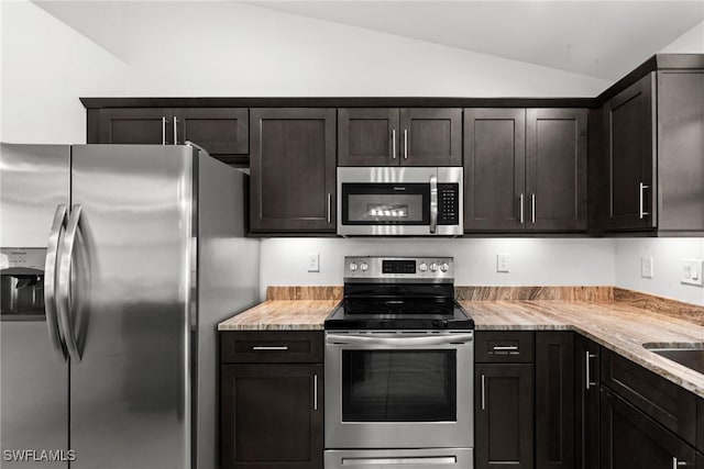 3734 SE 3rd Pl, Cape Coral, FL 33904 - kitchen featuring light stone countertops, dark brown cabinetry, vaulted ceiling, and stainless steel appliances