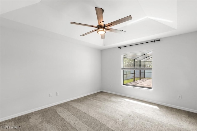 3734 SE 3rd Pl, Cape Coral, FL 33904 - unfurnished room with a tray ceiling, baseboards, a ceiling fan, and carpet