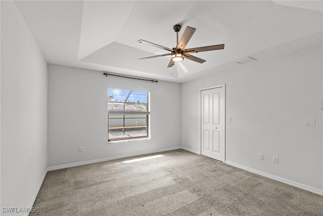 3734 SE 3rd Pl, Cape Coral, FL 33904 - empty room featuring carpet floors, baseboards, a ceiling fan, and a tray ceiling