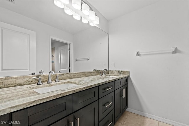 3734 SE 3rd Pl, Cape Coral, FL 33904 - bathroom with a sink, baseboards, double vanity, and tile patterned flooring