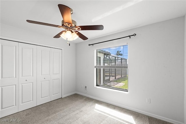 3734 SE 3rd Pl, Cape Coral, FL 33904 - unfurnished bedroom featuring a closet, baseboards, a ceiling fan, and carpet