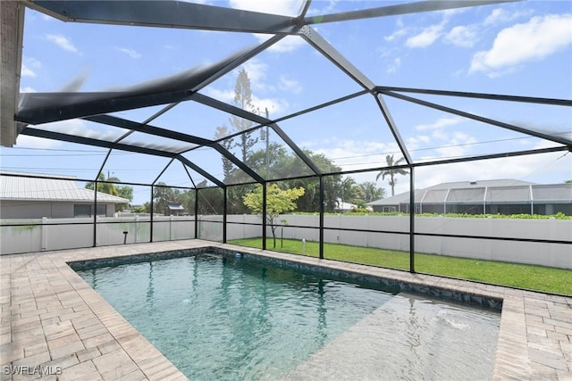 3734 SE 3rd Pl, Cape Coral, FL 33904 - view of pool featuring a lawn, fence, glass enclosure, a patio, and a fenced in pool