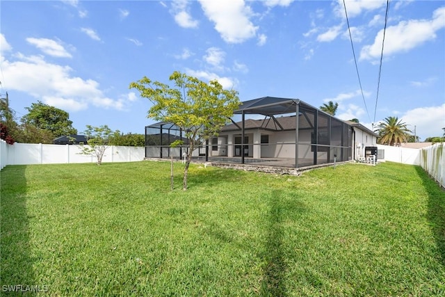 3734 SE 3rd Pl, Cape Coral, FL 33904 - view of yard with a fenced backyard and glass enclosure