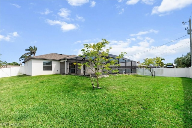 3734 SE 3rd Pl, Cape Coral, FL 33904 - back of house with a fenced backyard, stucco siding, a lanai, and a lawn