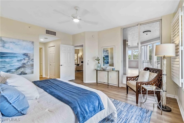 bedroom featuring wood finished floors and baseboards