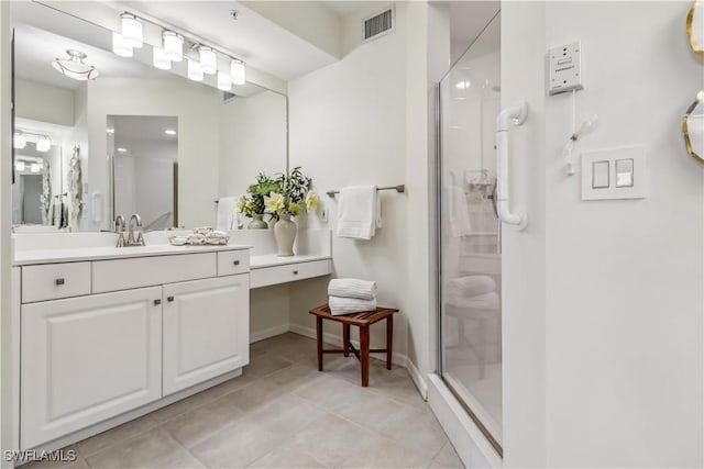 bathroom featuring a shower stall, tile patterned floors, vanity, and baseboards