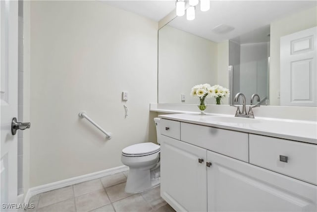 bathroom featuring tile patterned floors, toilet, baseboards, and vanity