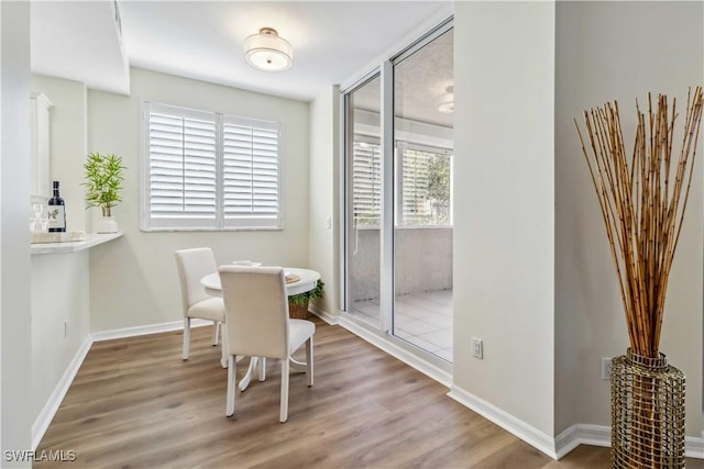 dining room featuring wood finished floors and baseboards