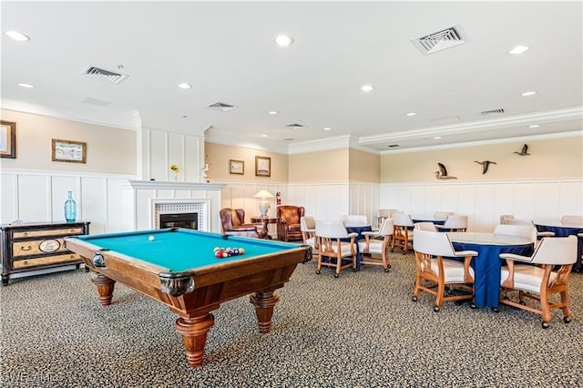 recreation room featuring crown molding, a decorative wall, a wainscoted wall, billiards table, and a tiled fireplace