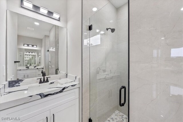 full bathroom with a stall shower and vanity