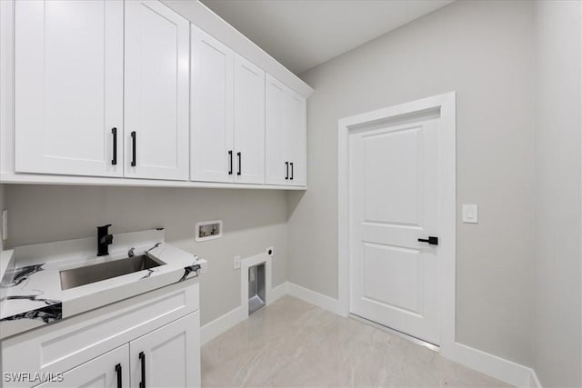 laundry area featuring hookup for a washing machine, baseboards, cabinet space, electric dryer hookup, and a sink