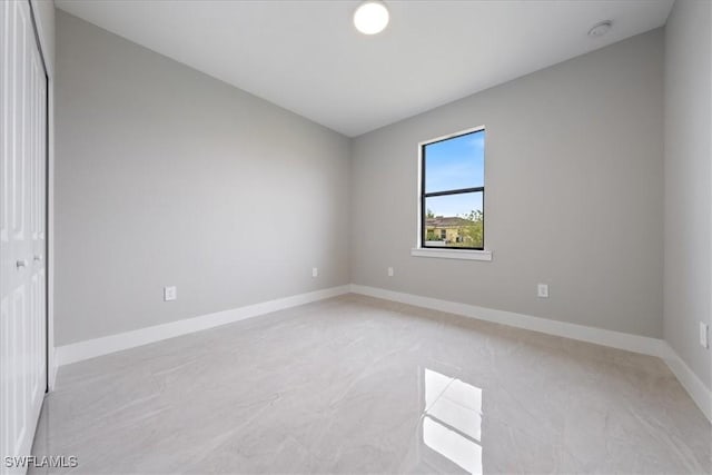 empty room featuring baseboards