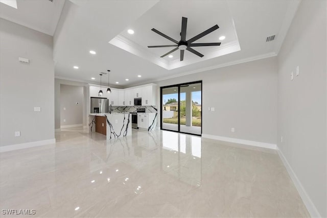 unfurnished living room with a tray ceiling, baseboards, visible vents, and ceiling fan