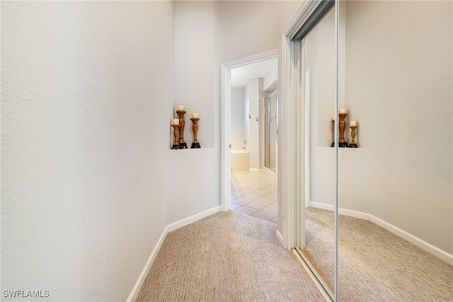corridor featuring carpet floors and baseboards
