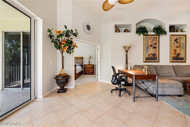office area featuring a ceiling fan, light tile patterned floors, and baseboards