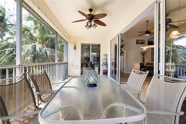 sunroom with ceiling fan, outdoor dining area, and plenty of natural light