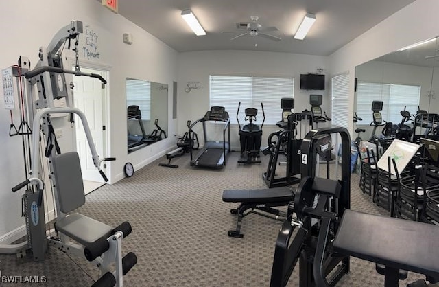 gym featuring a ceiling fan, carpet, baseboards, and lofted ceiling