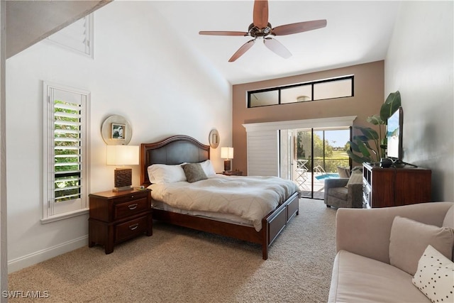 bedroom featuring multiple windows, baseboards, access to outside, and light colored carpet