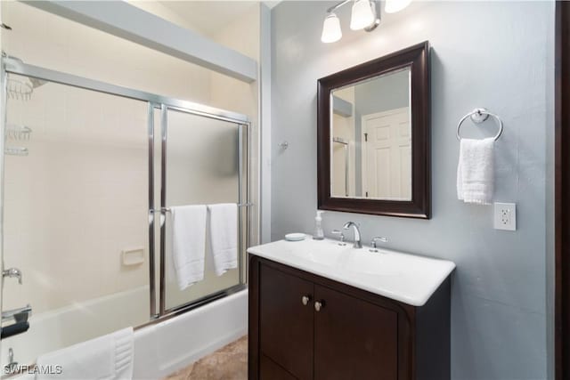 full bathroom with vanity and bath / shower combo with glass door