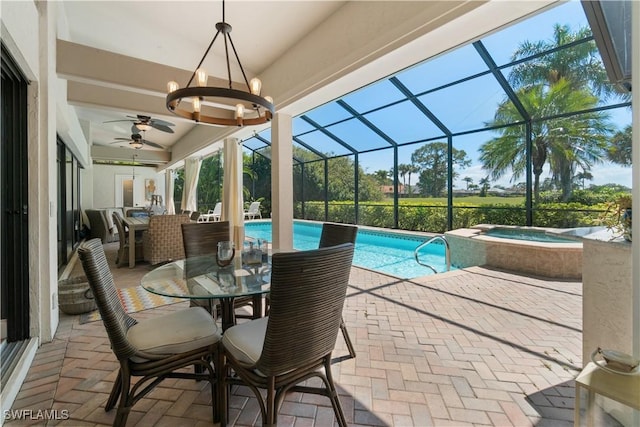 view of pool with glass enclosure, a pool with connected hot tub, a patio, outdoor dining area, and ceiling fan