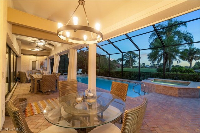 view of patio with outdoor dining space, a pool with connected hot tub, a lanai, and a ceiling fan