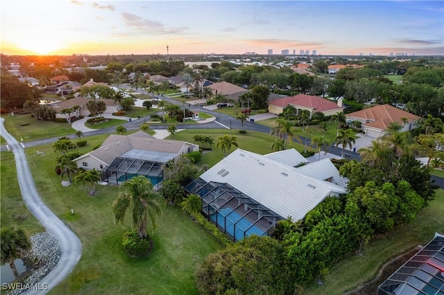aerial view at dusk featuring a residential view