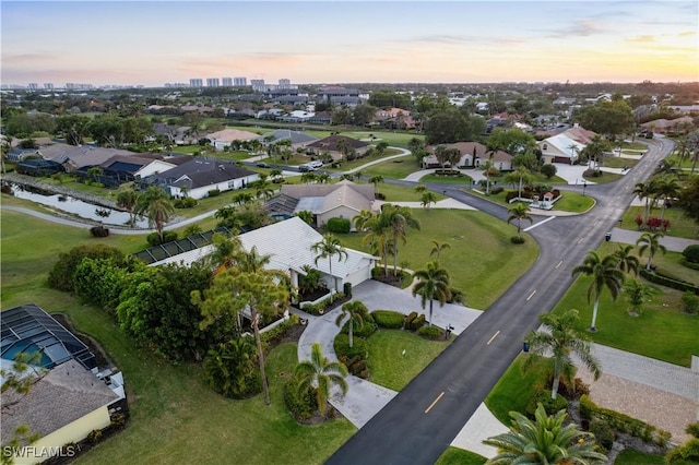 birds eye view of property featuring a residential view and a water view