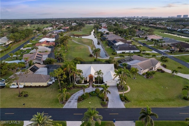 aerial view at dusk featuring a residential view