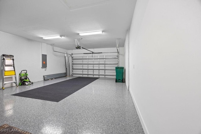 garage featuring electric panel and a garage door opener