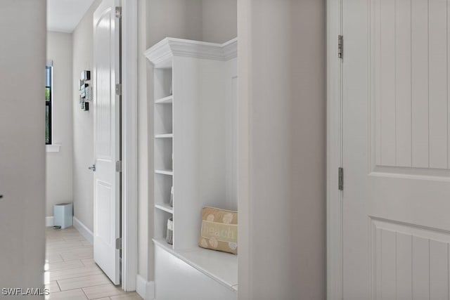 hall with baseboards and wood tiled floor