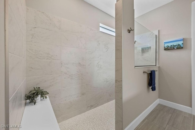 full bath featuring a walk in shower and baseboards