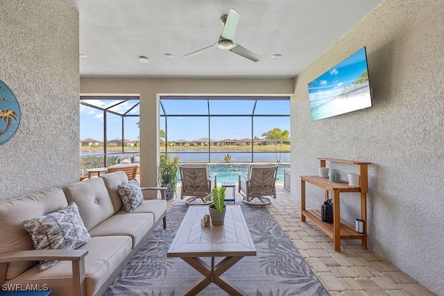 sunroom with an outdoor living space and a ceiling fan