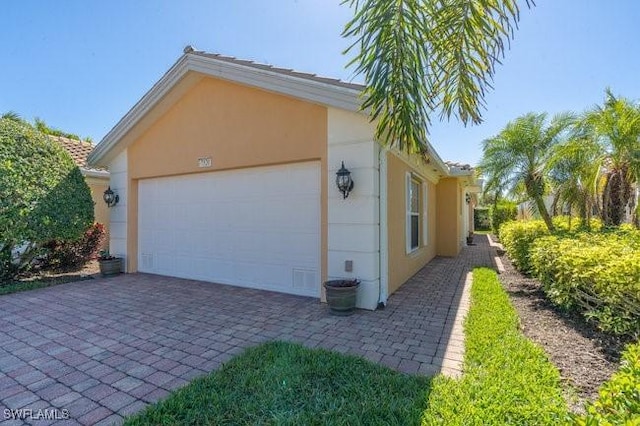 7520 Firenze Ln, Naples, FL 34114 - exterior space with stucco siding and decorative driveway