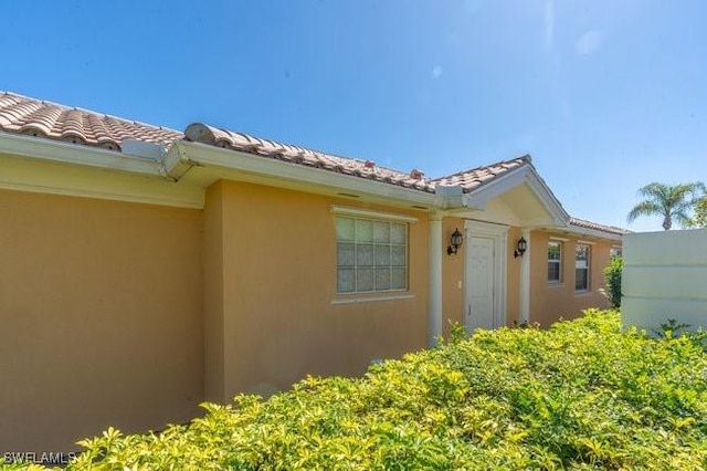 7520 Firenze Ln, Naples, FL 34114 - view of property exterior featuring a tile roof and stucco siding