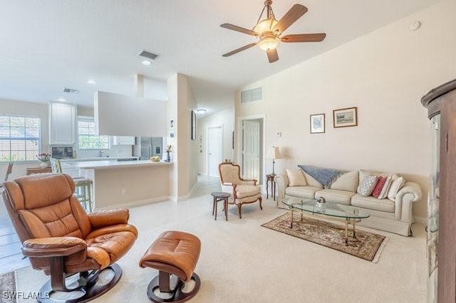 7520 Firenze Ln, Naples, FL 34114 - living room with visible vents, light colored carpet, ceiling fan, and vaulted ceiling