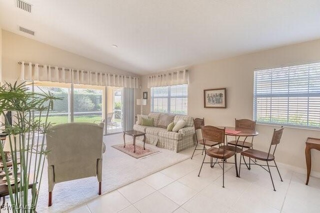 7520 Firenze Ln, Naples, FL 34114 - tiled living area featuring visible vents, lofted ceiling, and baseboards