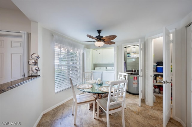 dining area featuring baseboards, separate washer and dryer, ceiling fan, and water heater