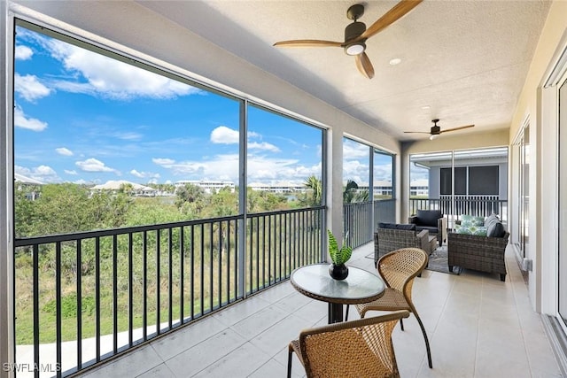 sunroom featuring a ceiling fan