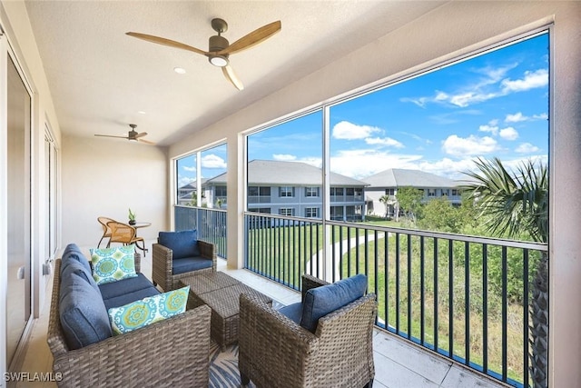 sunroom featuring a residential view and ceiling fan