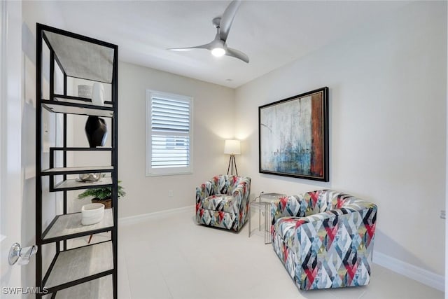 sitting room with baseboards and ceiling fan