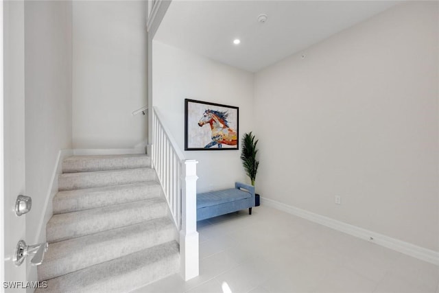 stairs with tile patterned floors, recessed lighting, and baseboards