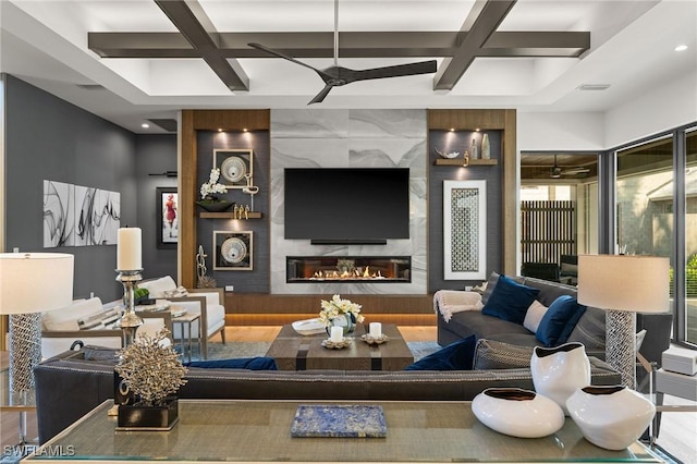 living room featuring visible vents, a premium fireplace, a ceiling fan, beam ceiling, and coffered ceiling