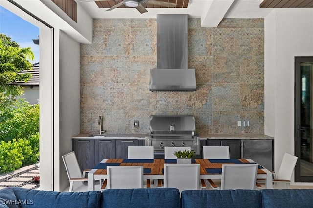 exterior space featuring area for grilling, outdoor dining space, a ceiling fan, a sink, and an outdoor kitchen