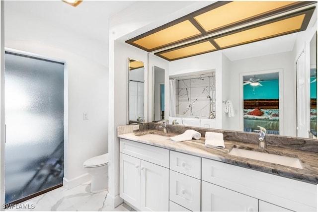 ensuite bathroom featuring marble finish floor, double vanity, toilet, and a sink