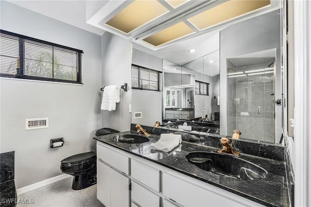 bathroom featuring a shower stall, visible vents, toilet, and a sink