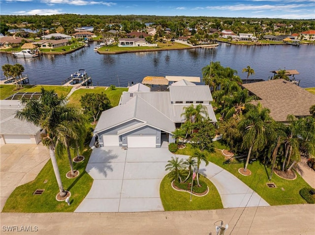 drone / aerial view with a water view and a residential view
